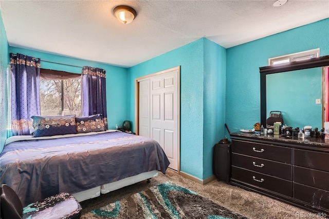 655 S Perry St, Denver, CO 80219 - carpeted bedroom featuring a textured ceiling, a closet, and a textured wall