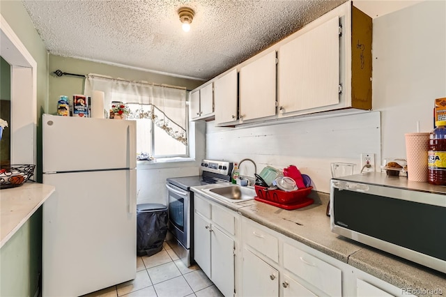 655 S Perry St, Denver, CO 80219 - kitchen featuring white cabinets, a textured ceiling, a sink, and appliances with stainless steel finishes