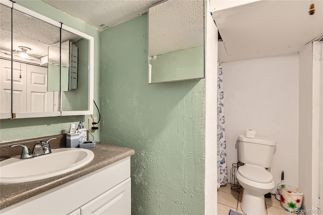 655 S Perry St, Denver, CO 80219 - bathroom with a textured wall, tile patterned flooring, vanity, and toilet