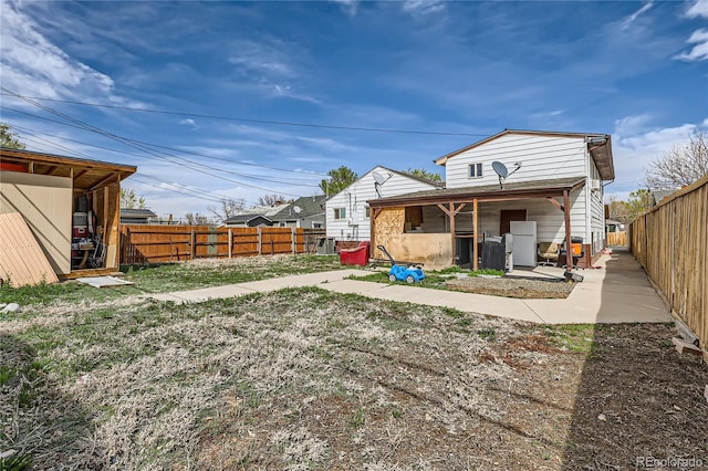 655 S Perry St, Denver, CO 80219 - back of property featuring a patio and a fenced backyard