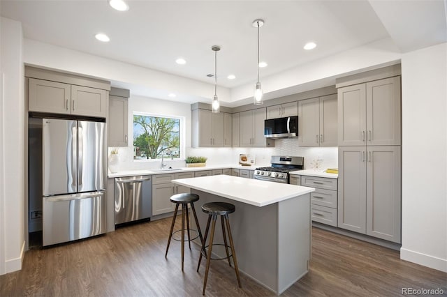 5189 Carr St, Arvada, CO 80002 - kitchen featuring appliances with stainless steel finishes, gray cabinets, decorative backsplash, and recessed lighting
