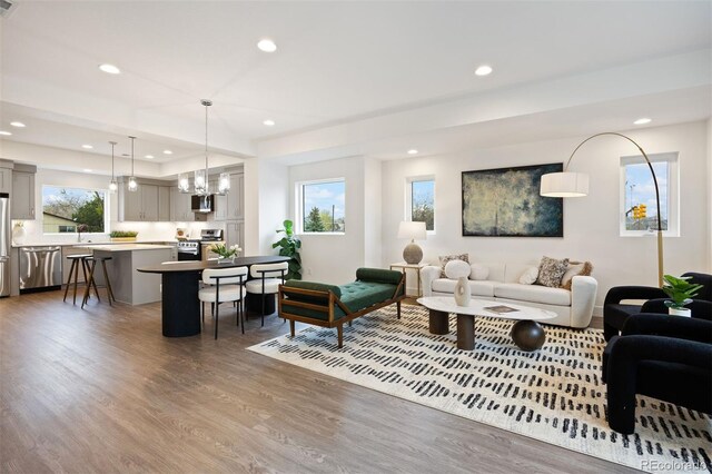 5189 Carr St, Arvada, CO 80002 - living area with wood finished floors, a chandelier, and recessed lighting