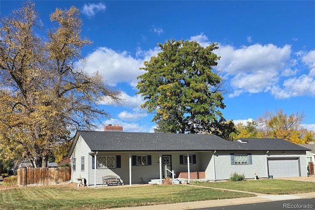 ranch-style house featuring a garage and a front lawn