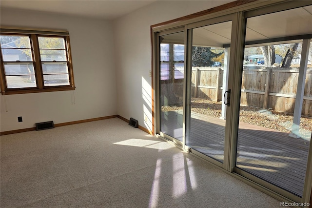 unfurnished room with plenty of natural light and carpet floors