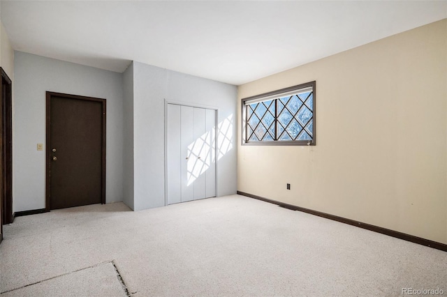 unfurnished bedroom featuring light carpet