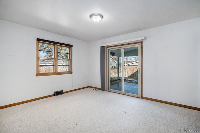 spare room with carpet floors and a healthy amount of sunlight