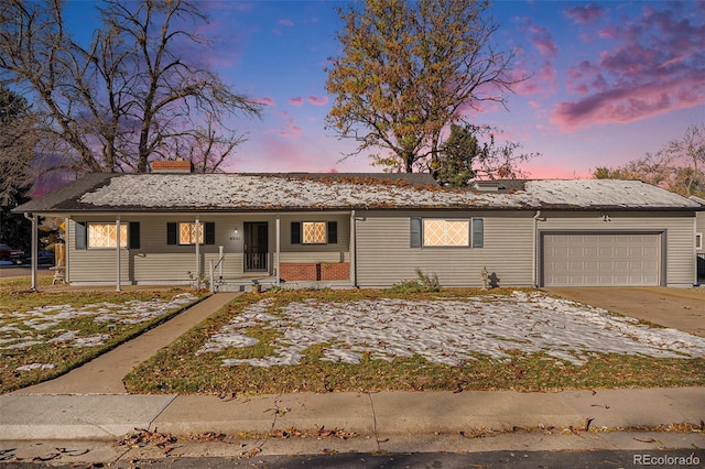 single story home featuring a garage and a porch