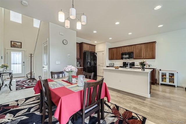 dining room with recessed lighting, a healthy amount of sunlight, and light wood finished floors