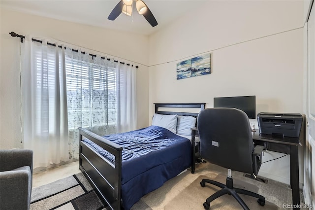 bedroom with ceiling fan, vaulted ceiling, visible vents, and carpet