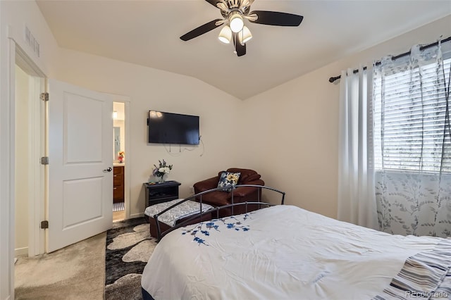 bedroom with ceiling fan, vaulted ceiling, visible vents, and carpet