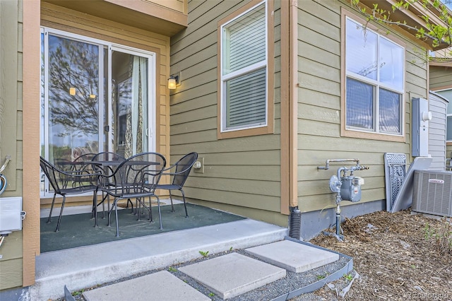 view of patio / terrace with cooling unit and outdoor dining space