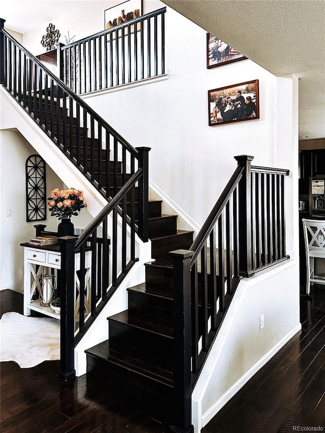 15468 W 50th Pl, Golden, CO 80403 - stairs featuring wood-type flooring and a textured ceiling