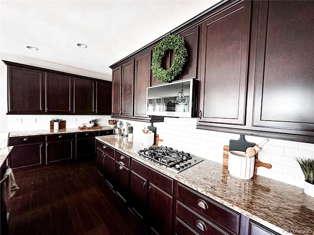 15468 W 50th Pl, Golden, CO 80403 - kitchen with gas cooktop, stainless steel microwave, light stone countertops, dark wood finished floors, and recessed lighting