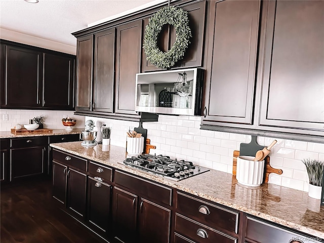 15468 W 50th Pl, Golden, CO 80403 - kitchen featuring stainless steel microwave, black gas cooktop, light stone countertops, backsplash, and dark wood-style floors