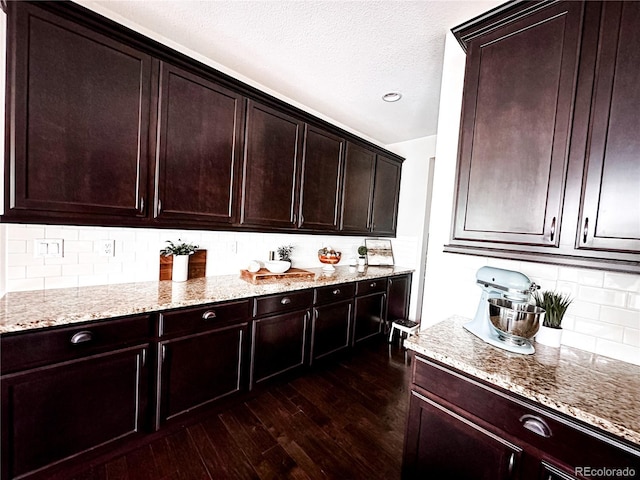 15468 W 50th Pl, Golden, CO 80403 - kitchen with light stone counters, dark wood-type flooring, backsplash, a textured ceiling, and dark brown cabinetry