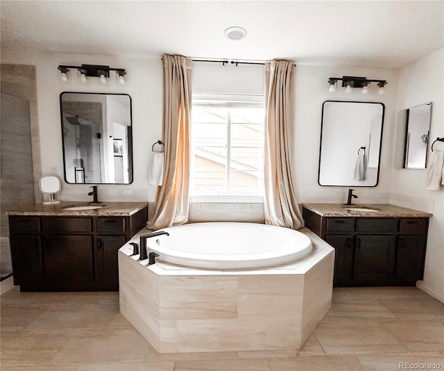 15468 W 50th Pl, Golden, CO 80403 - bathroom with a garden tub, two vanities, and tile patterned floors
