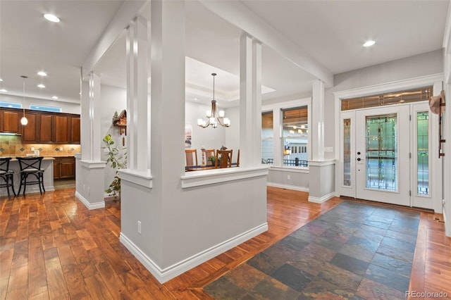 24906 E Geddes Cir, Aurora, CO 80016 - entrance foyer featuring recessed lighting, a chandelier, dark wood-style flooring, and decorative columns
