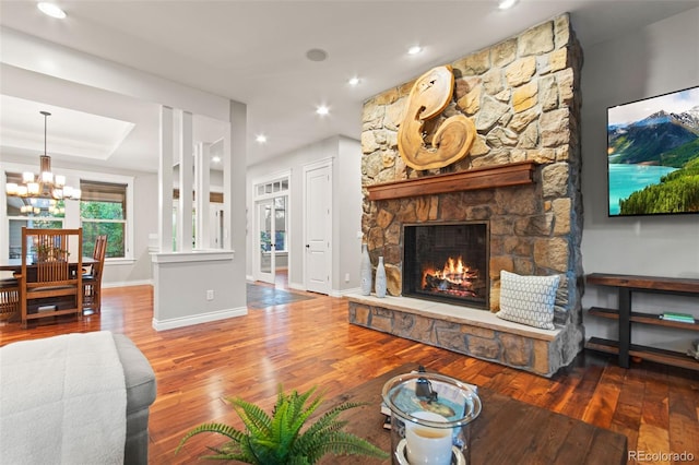 24906 E Geddes Cir, Aurora, CO 80016 - living area with hardwood / wood-style flooring, a chandelier, a stone fireplace, recessed lighting, and a raised ceiling