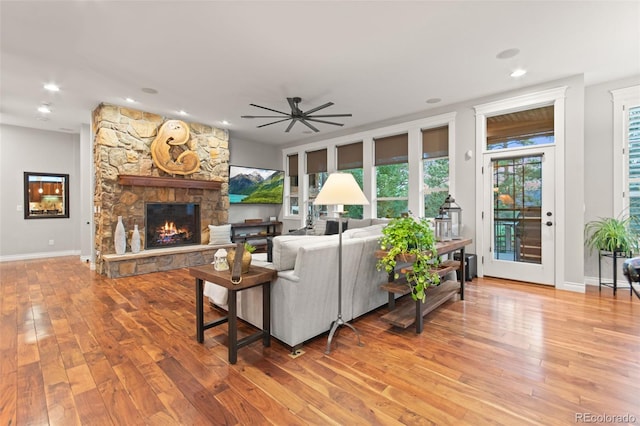 24906 E Geddes Cir, Aurora, CO 80016 - living area with a fireplace, plenty of natural light, hardwood / wood-style flooring, and recessed lighting