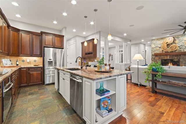 24906 E Geddes Cir, Aurora, CO 80016 - kitchen with appliances with stainless steel finishes, open floor plan, ceiling fan, decorative backsplash, and recessed lighting