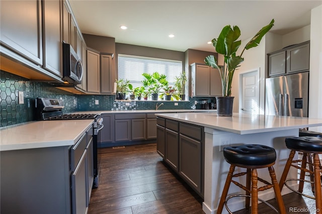 kitchen featuring a kitchen island, stainless steel appliances, and light countertops