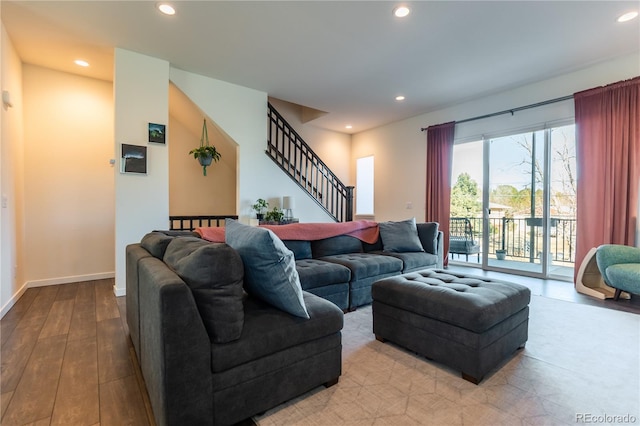 living area with recessed lighting, light wood-style flooring, baseboards, and stairs