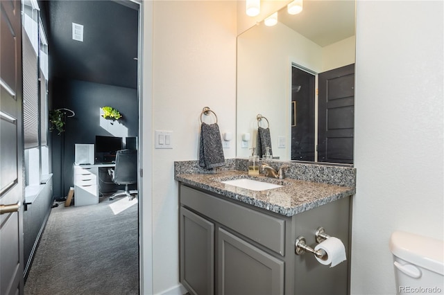 bathroom with toilet and vanity