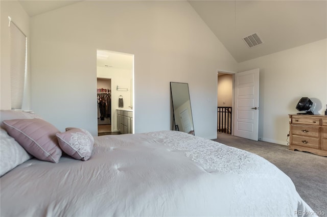 carpeted bedroom with baseboards, visible vents, a walk in closet, high vaulted ceiling, and a closet