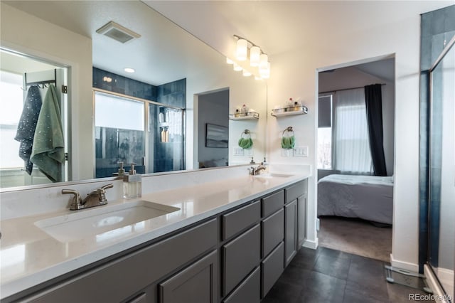 full bathroom featuring a sink, double vanity, visible vents, and connected bathroom