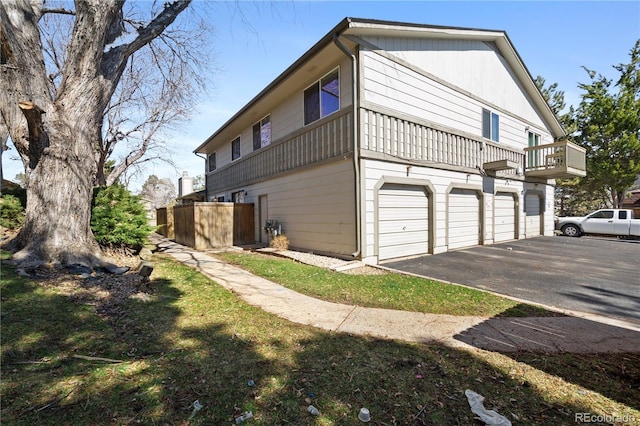 view of home's exterior featuring a balcony and a garage