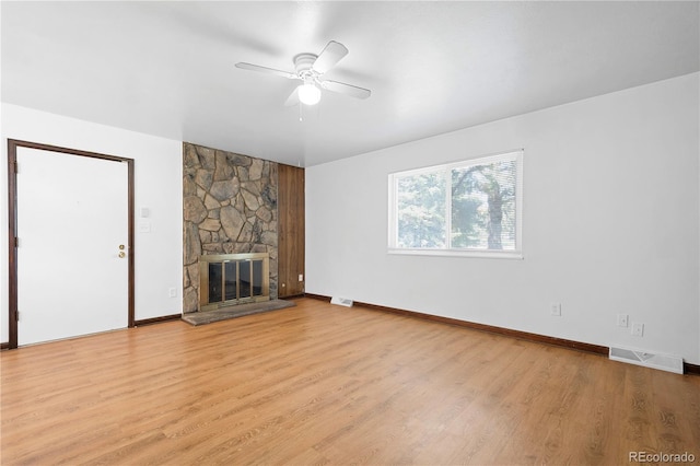 unfurnished living room featuring ceiling fan, a fireplace, and light hardwood / wood-style flooring