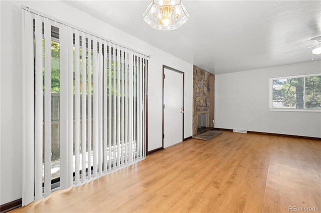 interior space with light wood-type flooring, access to outside, and a notable chandelier