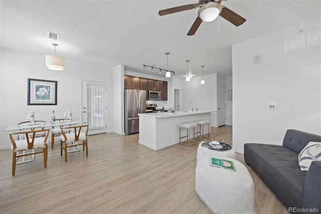 17353 Wilde Ave Unit 308, Parker, CO 80134 - living area featuring light wood-style flooring, track lighting, and ceiling fan