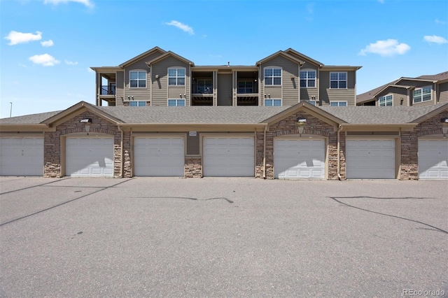 17353 Wilde Ave Unit 308, Parker, CO 80134 - townhome / multi-family property featuring stone siding, community garages, and a shingled roof