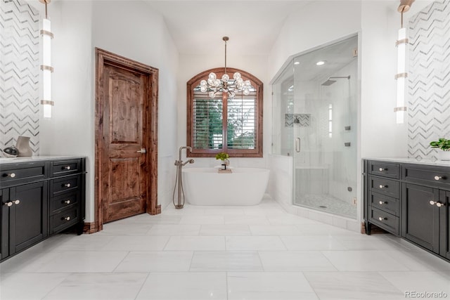 bathroom with tile patterned floors, vanity, shower with separate bathtub, and a notable chandelier