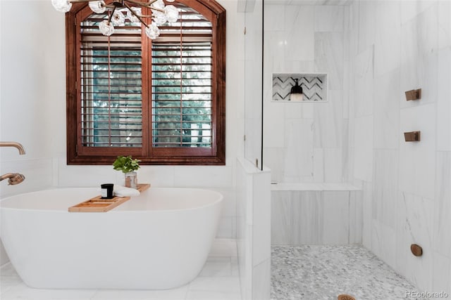 bathroom with tile walls and independent shower and bath