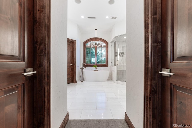 hallway with light tile patterned floors, lofted ceiling, and a notable chandelier