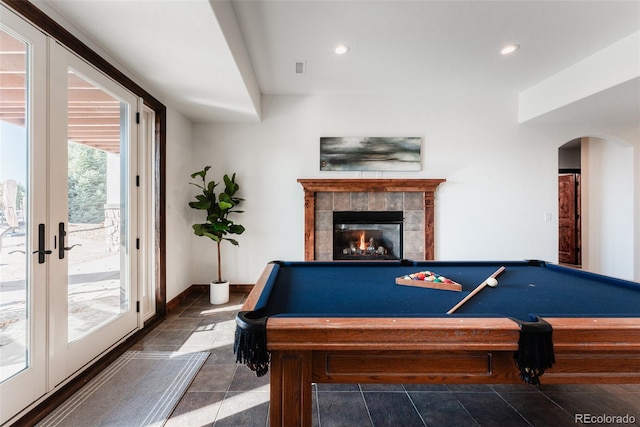 recreation room with a tile fireplace, french doors, dark tile patterned floors, and pool table