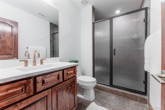 bathroom with toilet, vanity, and walk in shower