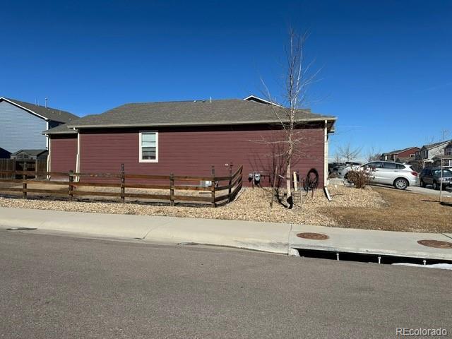 view of side of property featuring fence