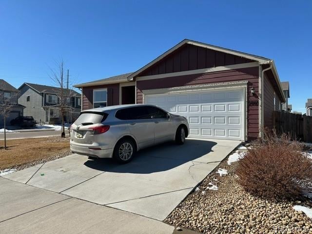 view of front facade with driveway, an attached garage, and board and batten siding