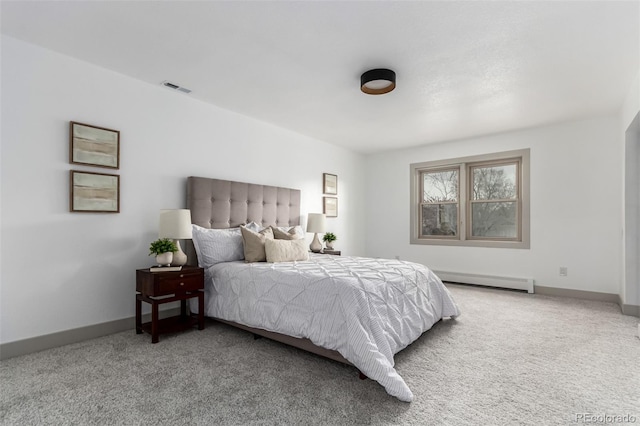 carpeted bedroom with baseboard heating