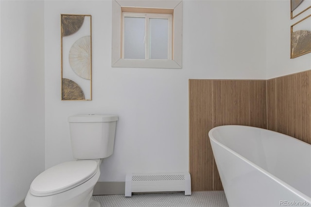 bathroom featuring toilet, a baseboard radiator, and a tub