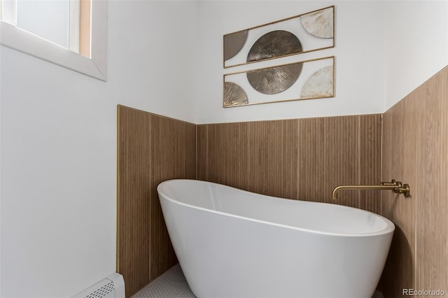 bathroom featuring a tub and baseboard heating