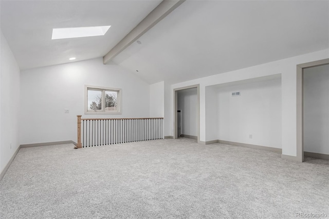 interior space with carpet floors and lofted ceiling with skylight