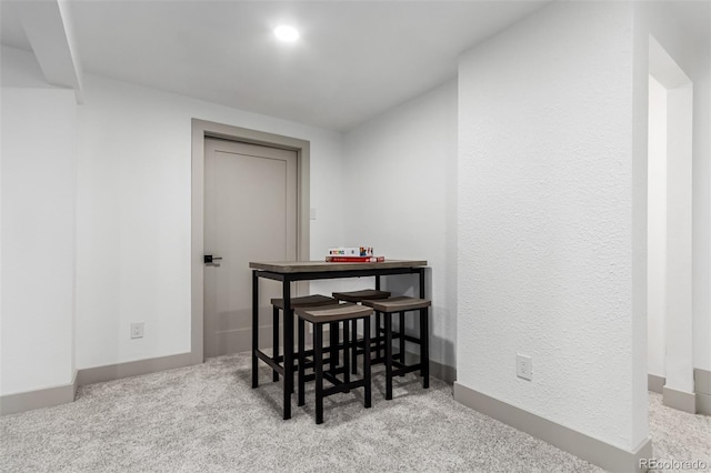 dining room with light carpet