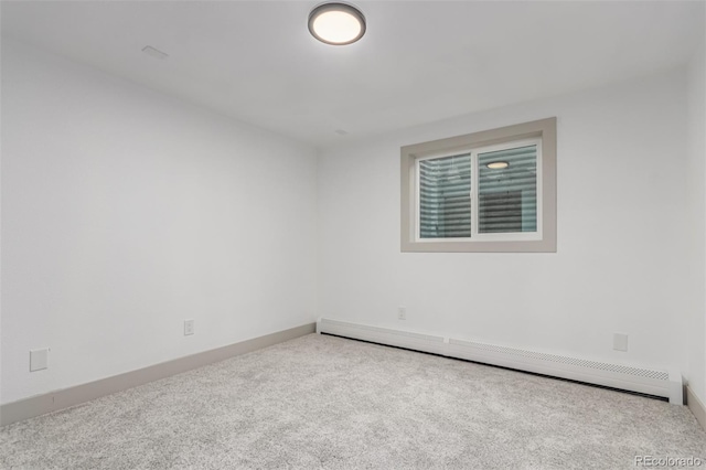 empty room with baseboard heating and light carpet