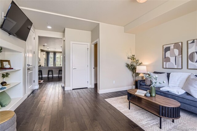 2700 E Louisiana Ave Unit 203, Denver, CO 80210 - living area with dark wood-style floors and baseboards