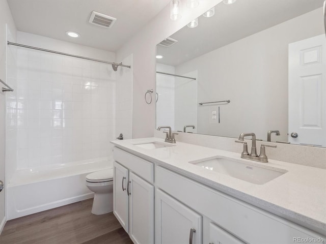 full bathroom with shower / bath combination, vanity, toilet, and wood-type flooring