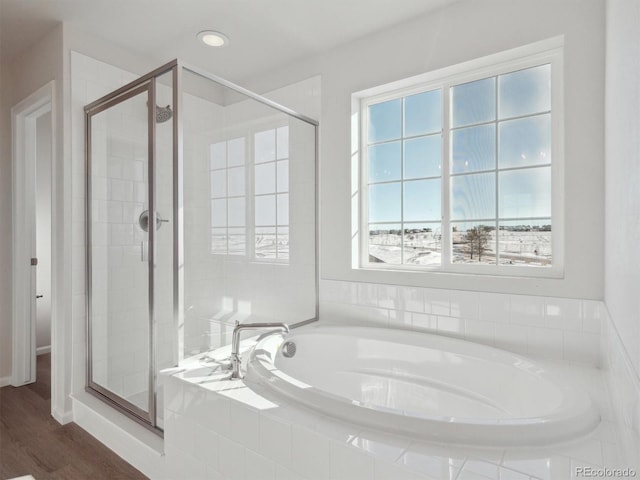 bathroom with plus walk in shower and hardwood / wood-style flooring